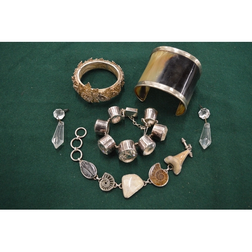 1104 - Three decorative silver bracelets, a horn and silver cuff bracelet and a pair of decorative earrings... 