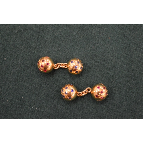 1107 - A pair of yellow metal and gem set ball shaped cufflinks.