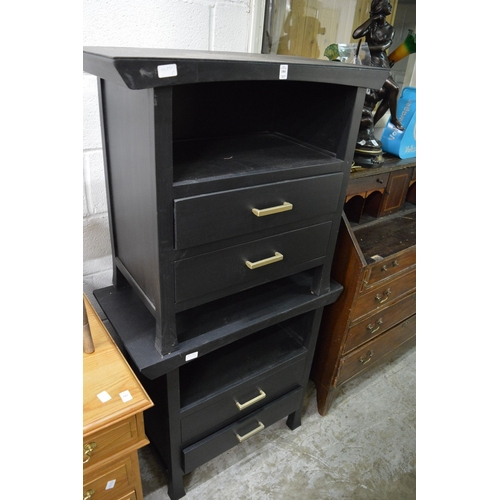 184 - A pair of black painted bedside chests.