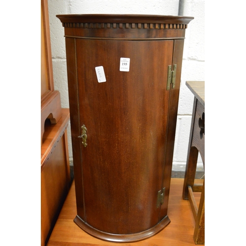 195 - A small mahogany hanging bow fronted corner cupboard.