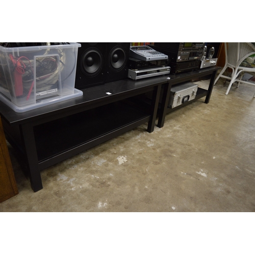 211 - A pair of ebonised two-tier coffee tables.