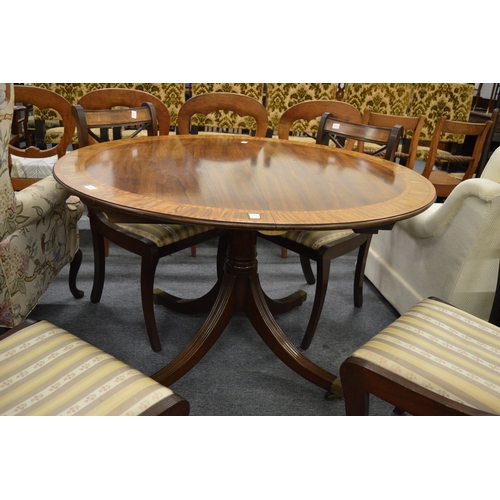 274 - A good Regency style mahogany tulip wood and rosewood banded circular extending dining table.