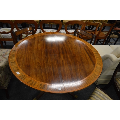 274 - A good Regency style mahogany tulip wood and rosewood banded circular extending dining table.