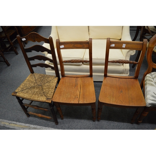 280 - A pair of 19th century elm dining chairs and a ladder back chair.