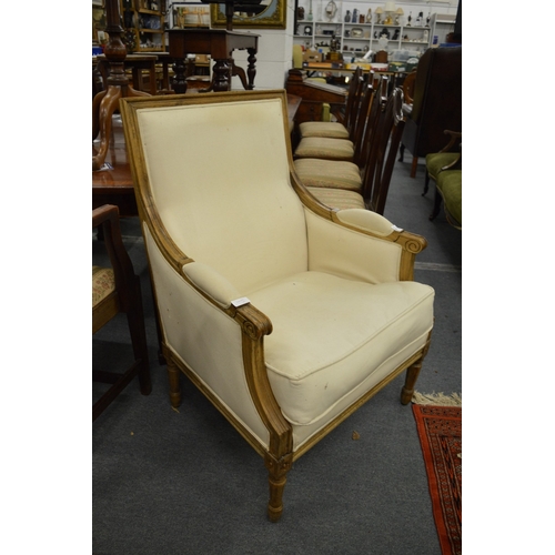 299 - A French beech wood framed cream upholstered armchair.