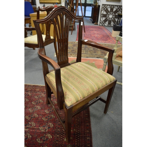 301 - A set of nine Georgian style mahogany dining chairs, one with arms.