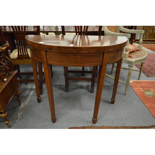 303 - A 19th century mahogany demi lune fold-over tea table.