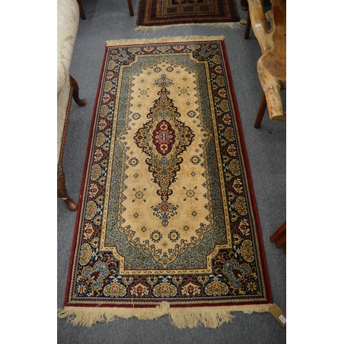 328 - A machine made Persian style rug, 184cm x 91cm.