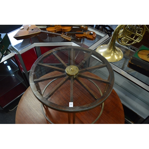 364 - An unusual glass and brass coffee table, the top formed as a wheel.