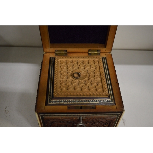 505 - An Eastern carved sandalwood and inlaid tea caddy.