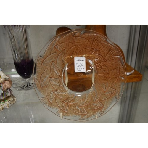 560 - A pair of Lalique moulded and tinted glass circular plates decorated with leaves.