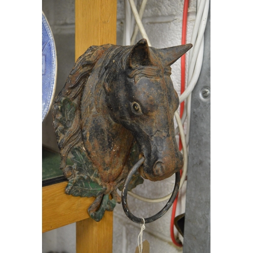 613 - A pair of painted cast iron horse head wall mounted tethers.