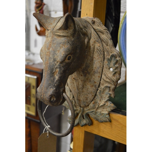 613 - A pair of painted cast iron horse head wall mounted tethers.