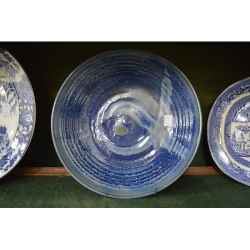 614 - Four large decorative dishes to include an oval serving dish, circular Chinese blue and white dish, ... 