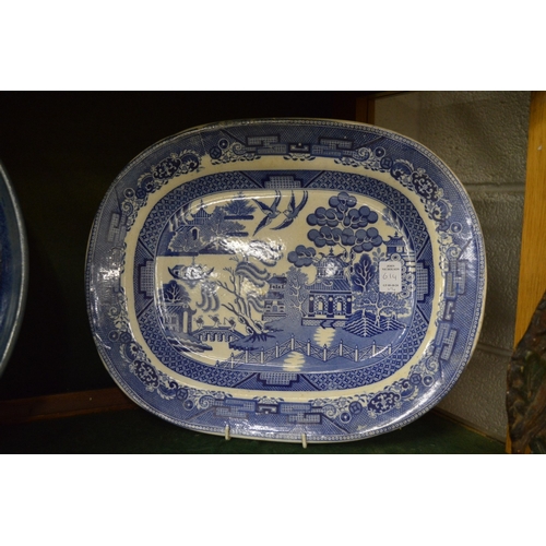 614 - Four large decorative dishes to include an oval serving dish, circular Chinese blue and white dish, ... 