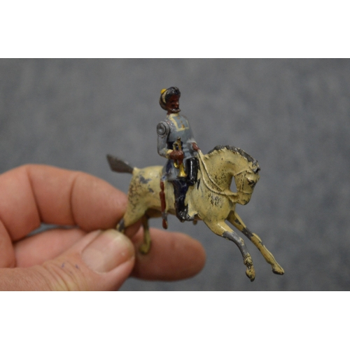 856 - A collection of painted dye-cast soldiers on horseback and other items.