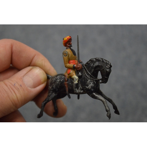 856 - A collection of painted dye-cast soldiers on horseback and other items.