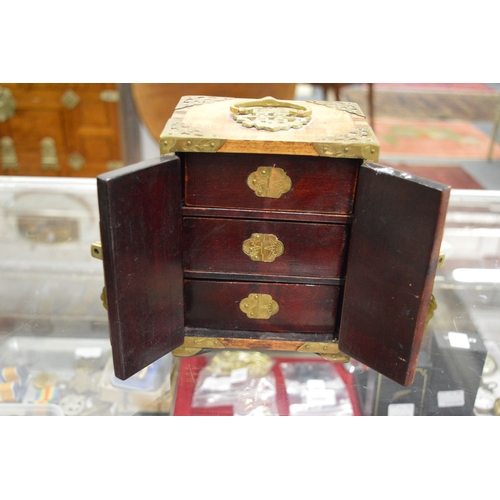 865 - A Chinese miniature table cabinet with inset hard stone panels.