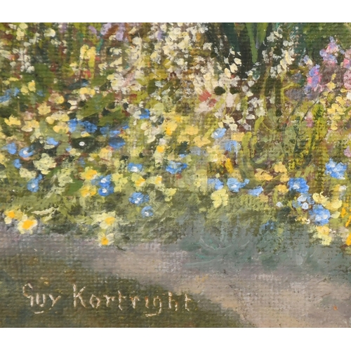 179 - Guy Kortright (1877-1939), a pair of oil on canvas garden scenes with abundant flowers in full bloom... 