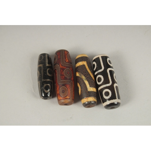 116 - FOUR AGATE DZI BEADS.