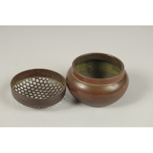 129 - A CHINESE CIRCULAR BRONZE CENSER AND COVER. 7cms.