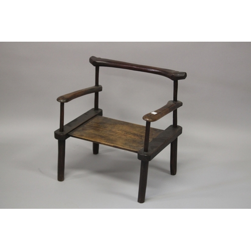 13 - A CARVED HARDWOOD LOW CHAIR. 59cm wide.