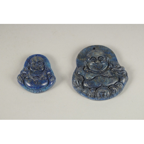 131 - TWO CARVED LAPIS PENDANTS.