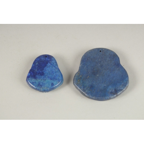 131 - TWO CARVED LAPIS PENDANTS.