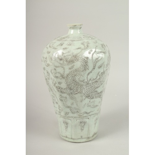 140 - A CHINESE CELADON GLAZE PORCELAIN MEIPING DRAGON VASE. 33cms high.