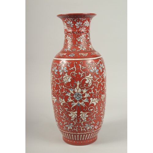 146 - A CHINESE RED GROUND BLUE AND WHITE PORCELAIN VASE. 46cms high.