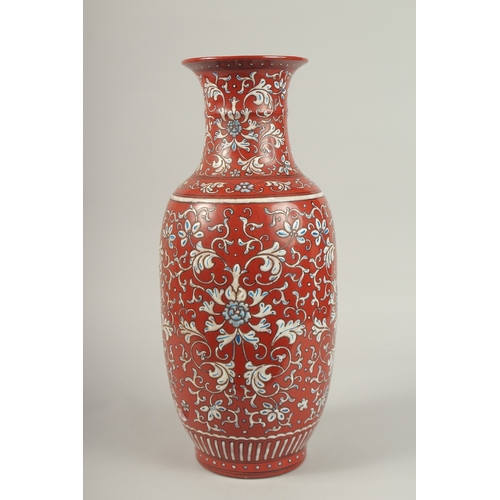 146 - A CHINESE RED GROUND BLUE AND WHITE PORCELAIN VASE. 46cms high.