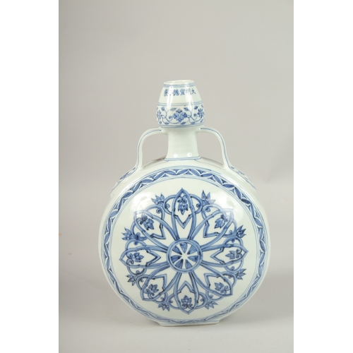 157 - A CHINESE BLUE AND WHITE TWIN-HANDLE MOON FLASK. 31cms high.