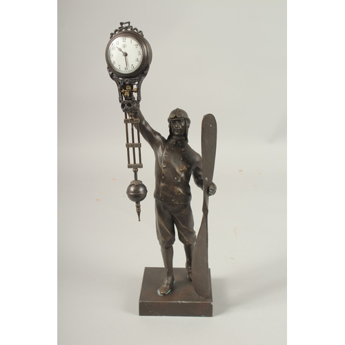 163 - AN AIRMAN BRONZED SWING CLOCK.
34cms high