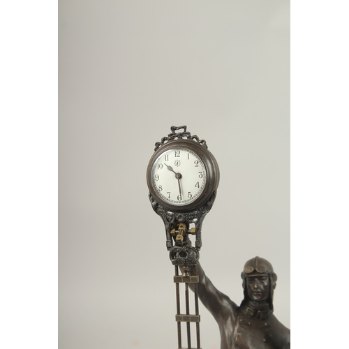 163 - AN AIRMAN BRONZED SWING CLOCK.
34cms high