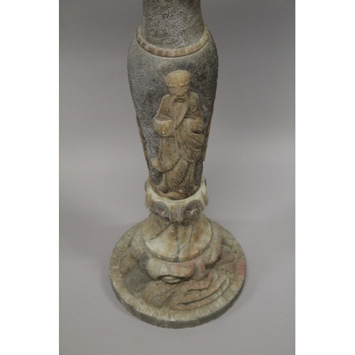 17 - A MARBLE COLUMN, the sides curved with Chinese figures with circular top and base. 94cm high.