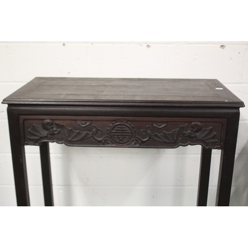 24 - A CHINESE HARDWOOD TABLE, 20TH CENTURY, with a rectangular top, bat carved frieze, a drawer to each ... 