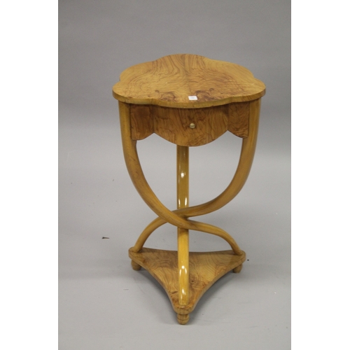 36 - A FRENCH STYLE BLOND WOOD SHAPED TOP OCCASIONAL TABLE, with a small drawer, on curving supports. 75c... 