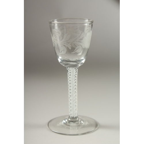 42 - A GEORGIAN WINE GLASS, the bowl engraved with roses, with air twist stem. 15cms high, tiny chip to t... 