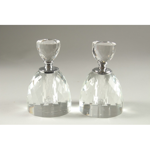 51 - A PAIR OF CRYSTAL CUT CIRCULAR SCENT BOTTLES.