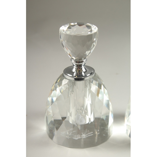 51 - A PAIR OF CRYSTAL CUT CIRCULAR SCENT BOTTLES.