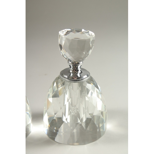 51 - A PAIR OF CRYSTAL CUT CIRCULAR SCENT BOTTLES.