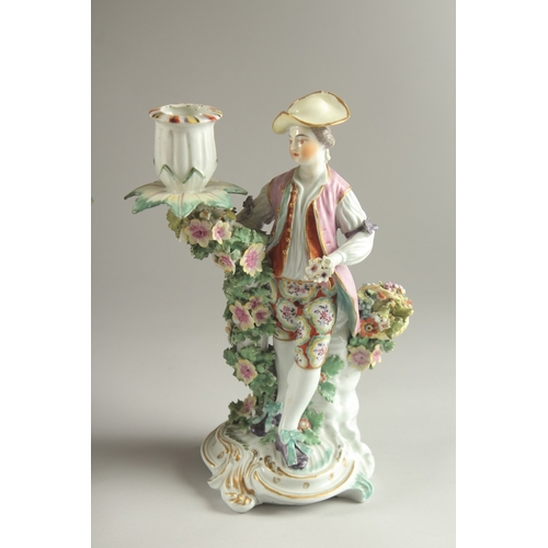 61 - A PAIR OF DERBY FIGURE CANDLESTICKS, as a woman and man, encrusted with flowers, each with a candle ... 