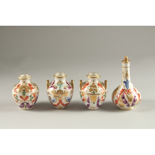 62 - A GARNITURE OF FOUR SMALL PIECES OF CROWN DERBY, scent bottle & stopper and three small vases. Mark ... 