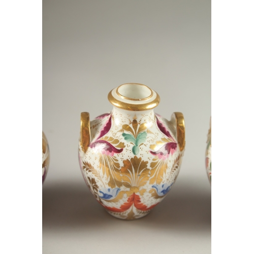 62 - A GARNITURE OF FOUR SMALL PIECES OF CROWN DERBY, scent bottle & stopper and three small vases. Mark ... 