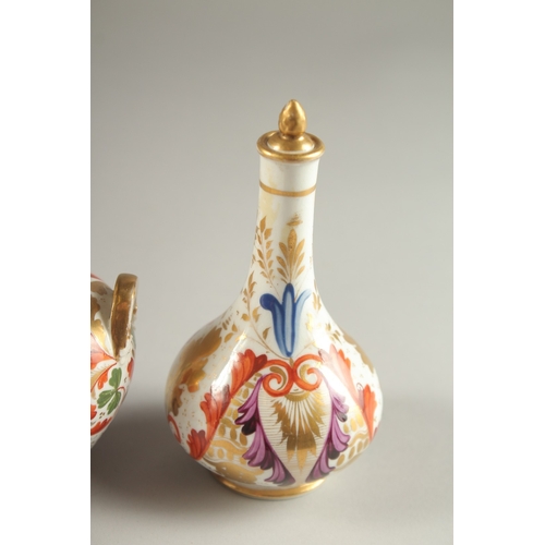 62 - A GARNITURE OF FOUR SMALL PIECES OF CROWN DERBY, scent bottle & stopper and three small vases. Mark ... 