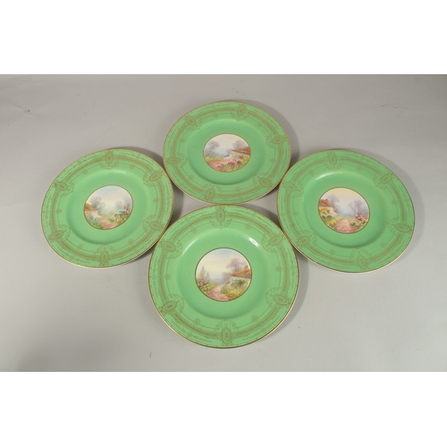 70 - A SET OF FOUR ROYAL WORCESTER CIRCULAR GREEN PLATES the centres painted with a college and flowers, ... 