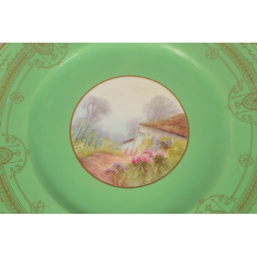 70 - A SET OF FOUR ROYAL WORCESTER CIRCULAR GREEN PLATES the centres painted with a college and flowers, ... 