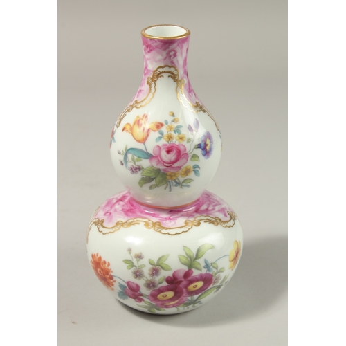 78 - A GOOD FRENCH PORCELAIN DOUBLE GOURD VASE painted with Turkish scenes and flowers. 20cms high.