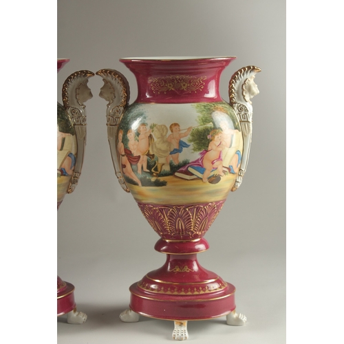 82 - A PAIR OF SEVRES DESIGN RED GROUND TWO HANDLED VASES with classical designs. 40cms high.