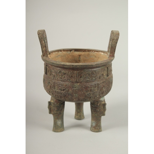 91 - AN ARCHAIC BRONZE TWO HANDLED CIRCULAR CENSER. 23cms high x 16cms wide.